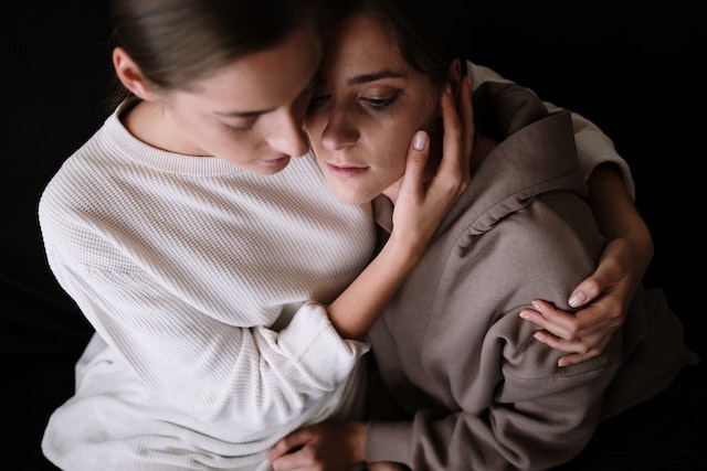 Two women embracing in a moment of emotional support – symbolizing the Cancer zodiac sign’s nurturing, compassionate, and deeply loyal nature in relationships