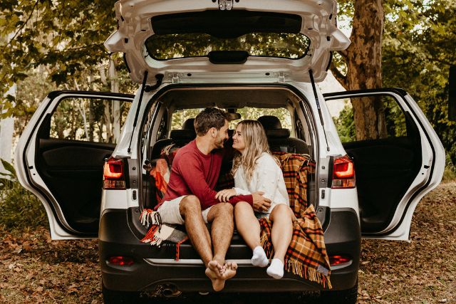 Romantic couple sitting close in the back of a car – representing Taurus and Scorpio zodiac compatibility marked by loyalty, intimacy, and emotional depth